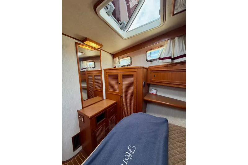 Queenie Yacht Photos Pics Interior of 1988 Offshore Yachts 48 Sedan, featuring wood cabinetry and skylight.