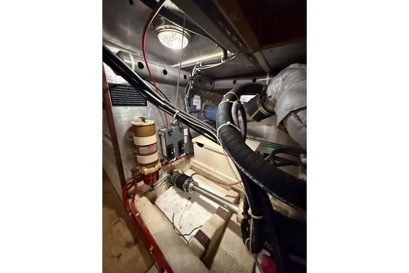 Queenie Yacht Photos Pics Engine room of 1988 Offshore Yachts 48 Sedan with visible components and wiring.