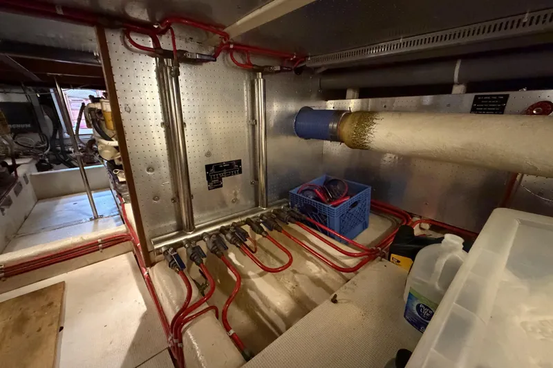 Queenie Yacht Photos Pics Engine room of 1988 Offshore Yachts 48 Sedan with visible piping and equipment.