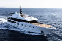 Luxurious 2007 Austal Displacement yacht with helipad cruising on open sea.