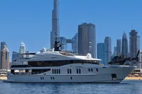 Luxurious 2007 Austal Displacement yacht with helicopter, Dubai skyline in background.