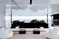 Luxurious yacht interior with modern seating, wooden tables, and ocean view. Austal Displacement, 2007.