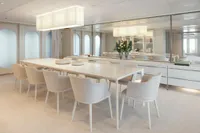Luxurious dining area on 2007 Austal Displacement yacht, featuring elegant white decor and modern furnishings.
