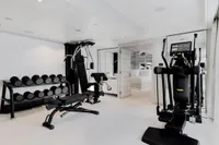 Luxurious yacht gym with modern equipment, featuring weights and exercise machines, Austal Displacement 2007.