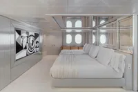 Luxurious yacht bedroom with modern art, mirrors, and large bed, Austal Displacement 2007.