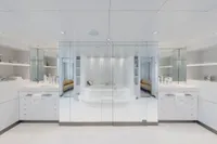 Luxurious modern bathroom with glass walls, white decor, and a central bathtub on an Austal Displacement yacht.