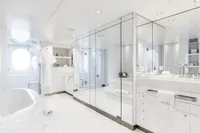 Luxurious yacht bathroom with white decor, marble surfaces, and modern fixtures, Austal Displacement 2007.