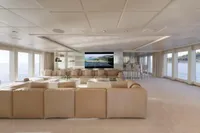 Luxurious yacht interior with beige sofas, large windows, and a flat-screen TV, Austal Displacement 2007.