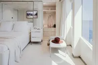 Luxurious yacht bedroom with ocean view, featuring elegant decor and modern furnishings, Austal Displacement 2007.