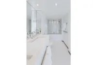 Luxurious white bathroom with modern fixtures on Austal Displacement yacht, 2007 model.