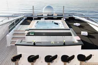 Luxurious 2007 Austal Displacement yacht deck with jacuzzi and bar seating.
