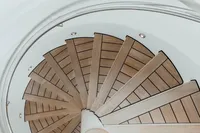 Spiral staircase with wooden steps on a 2007 Austal Displacement model.