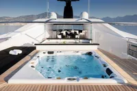Luxurious yacht deck with jacuzzi, bar, and scenic ocean view; Austal Displacement 2007 model.