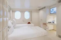 Luxurious cabin interior on 2007 Austal Displacement yacht with twin beds and modern decor.