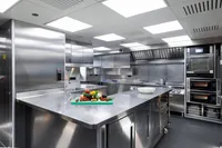 Modern stainless steel kitchen on Austal Displacement vessel, 2007, with fresh vegetables on counter.