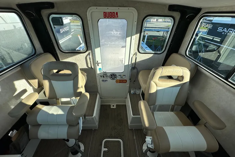 Fortuna Yacht Photos Pics 2019 Parker 2820 XLD Sport Cabin interior with beige seating and windows.