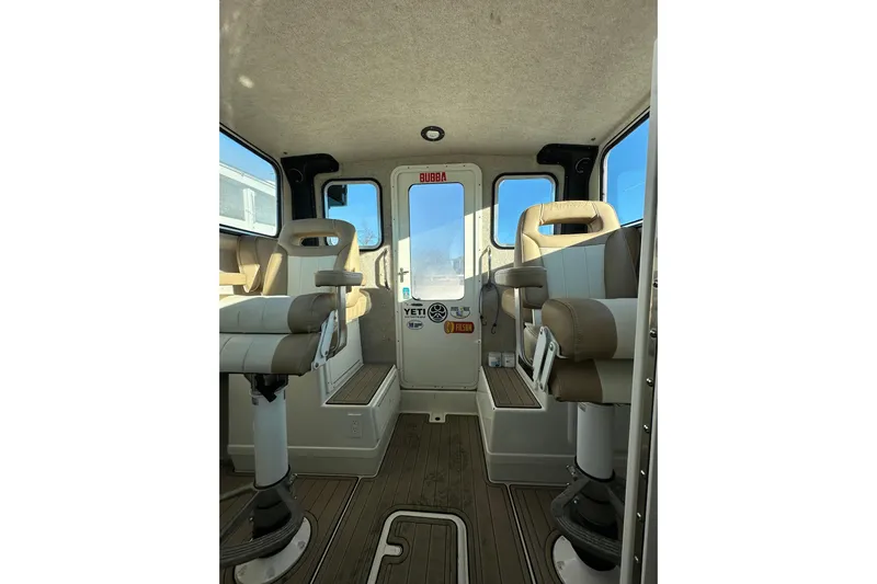 Fortuna Yacht Photos Pics Interior of 2019 Parker 2820 XLD Sport Cabin with beige seating and wood flooring.