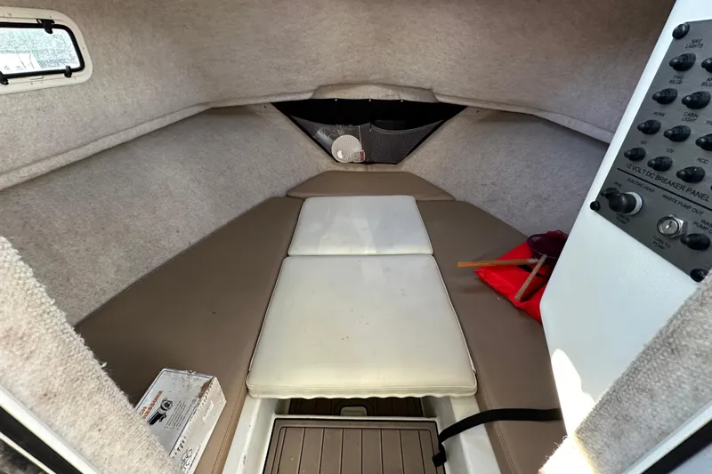 Fortuna Yacht Photos Pics 2019 Parker 2820 XLD Sport Cabin interior with cushioned seating and control panel.