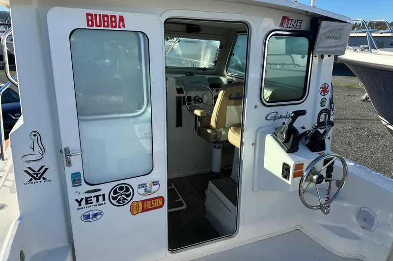 Fortuna Yacht Photos Pics 2019 Parker 2820 XLD Sport Cabin boat interior with steering wheel and control panel.
