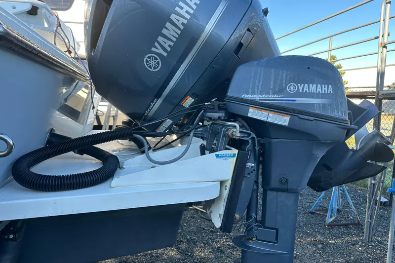 Fortuna Yacht Photos Pics 2019 Parker 2820 XLD Sport Cabin with Yamaha outboard motor, docked outdoors.