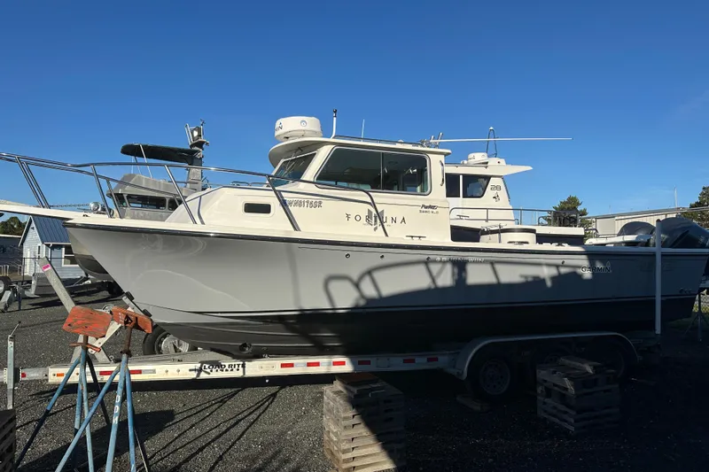 Fortuna Yacht Photos Pics 2019 Parker 2820 XLD Sport Cabin boat on trailer under clear blue sky.