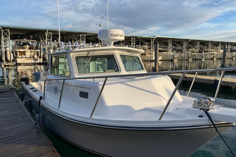 Fortuna Yacht Photos Pics 2019 Parker 2820 XLD Sport Cabin boat docked at marina with clear sky.