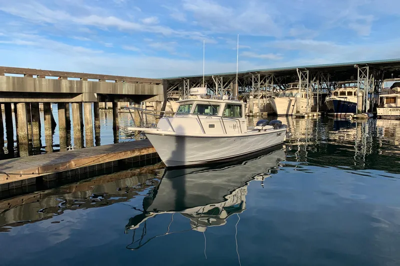 Fortuna Yacht Photos Pics 2019 Parker 2820 XLD Sport Cabin boat docked at a marina under clear skies.