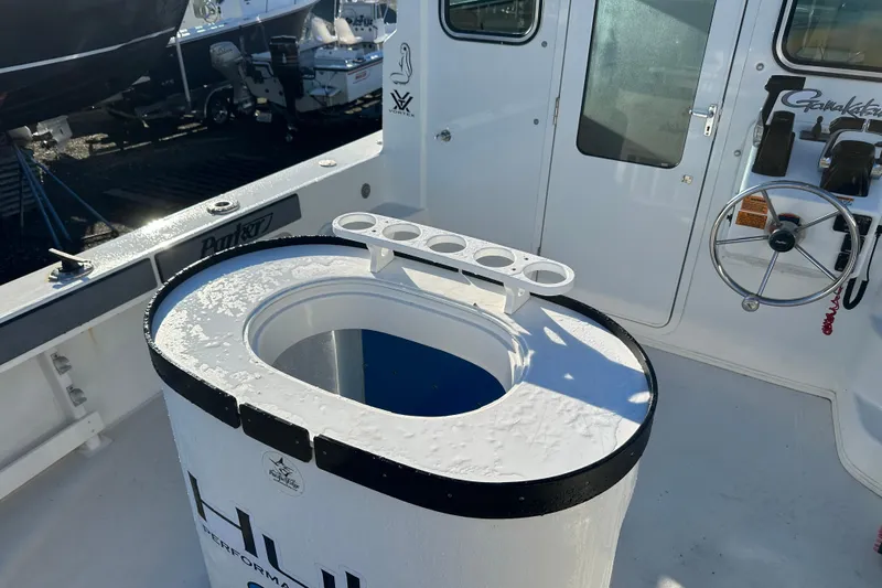 Fortuna Yacht Photos Pics 2019 Parker 2820 XLD Sport Cabin boat interior with steering wheel and rod holders.