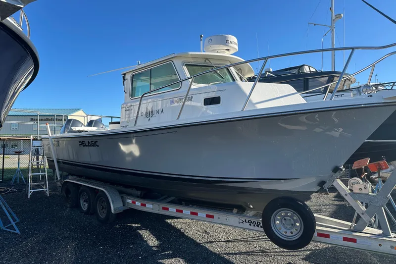 Fortuna Yacht Photos Pics 2019 Parker 2820 XLD Sport Cabin boat on trailer under clear blue sky.