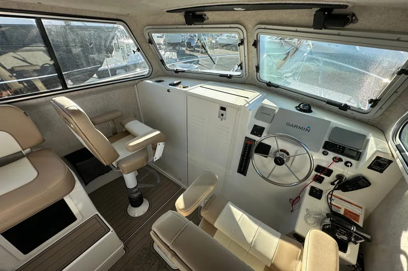 Fortuna Yacht Photos Pics 2019 Parker 2820 XLD Sport Cabin interior with steering wheel and Garmin navigation system.