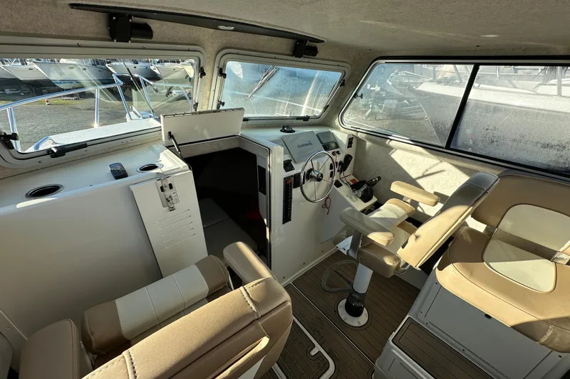 Fortuna Yacht Photos Pics 2019 Parker 2820 XLD Sport Cabin interior with helm and seating.