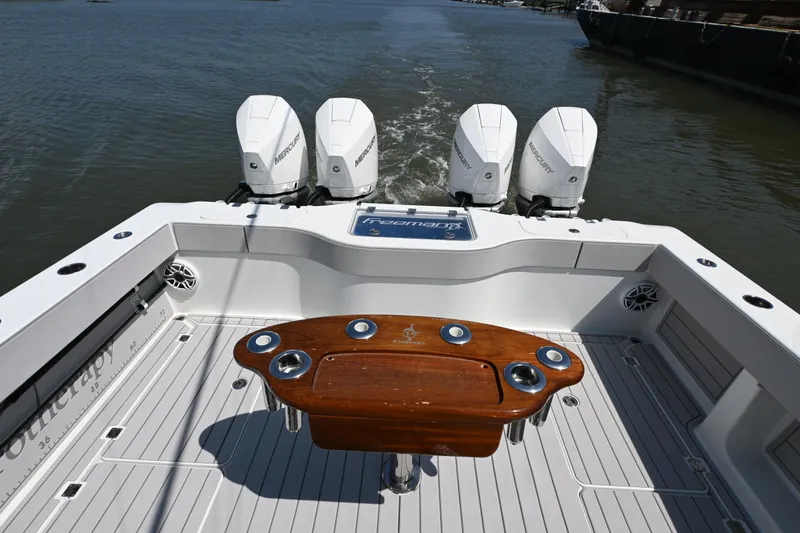  Yacht Photos Pics Freeman 37VH 2021 boat with four Mercury engines and a wooden table on deck.