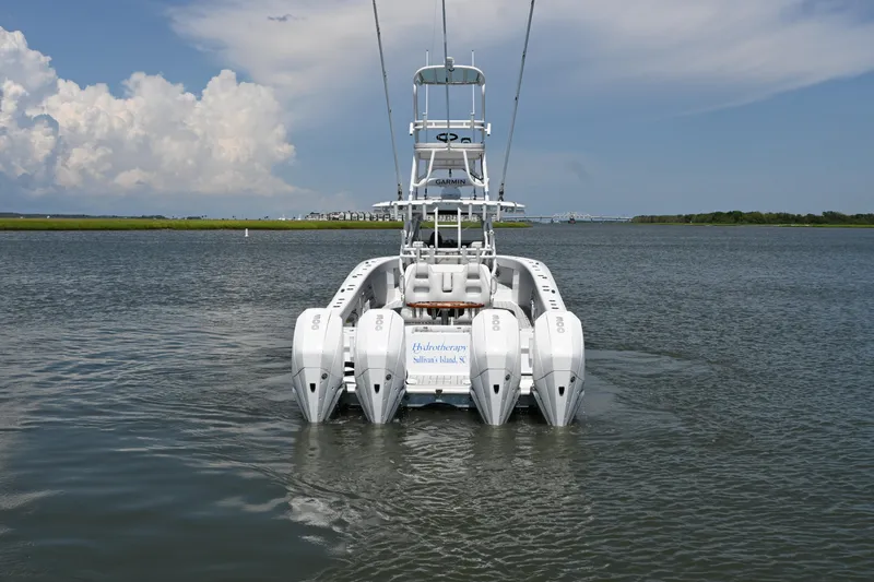  Yacht Photos Pics Freeman 37VH 2021 boat with four engines on calm water under a blue sky.