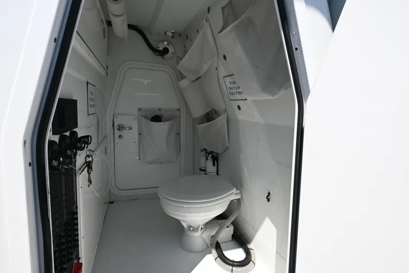  Yacht Photos Pics Interior of a 2021 Freeman 37VH boat bathroom with toilet and storage compartments.