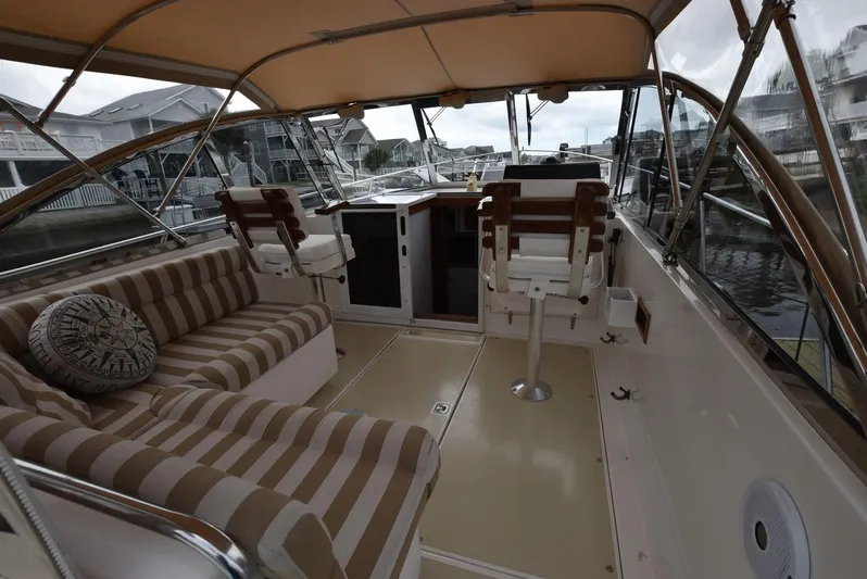 Don't Blink Yacht Photos Pics Interior of 1999 Legacy 34 Express boat with striped seating and helm station.