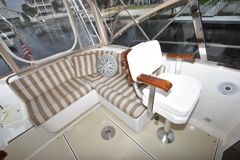 Don't Blink Yacht Photos Pics Interior of 1999 Legacy 34 Express boat with striped seating and captain's chair.