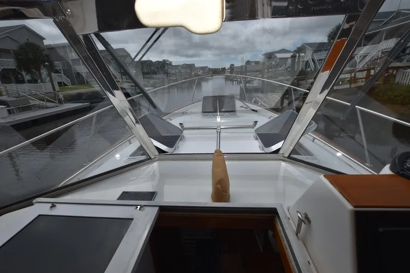 Don't Blink Yacht Photos Pics 1999 Legacy 34 Express boat interior view, featuring sleek design and canal backdrop.