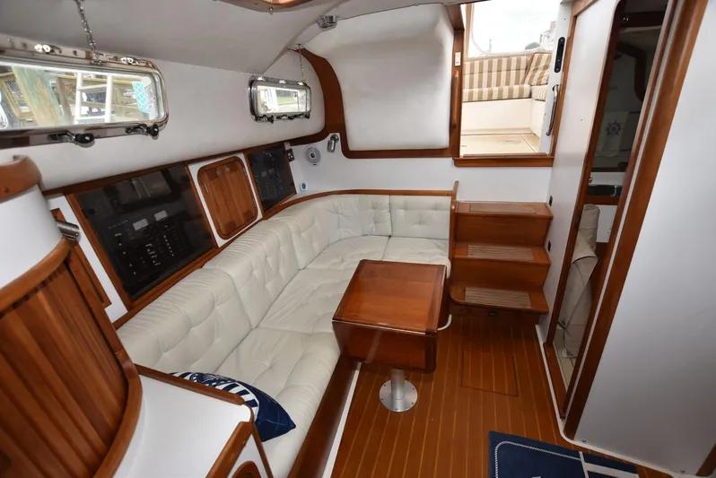 Don't Blink Yacht Photos Pics Interior of 1999 Legacy 34 Express yacht with wood accents and white seating.