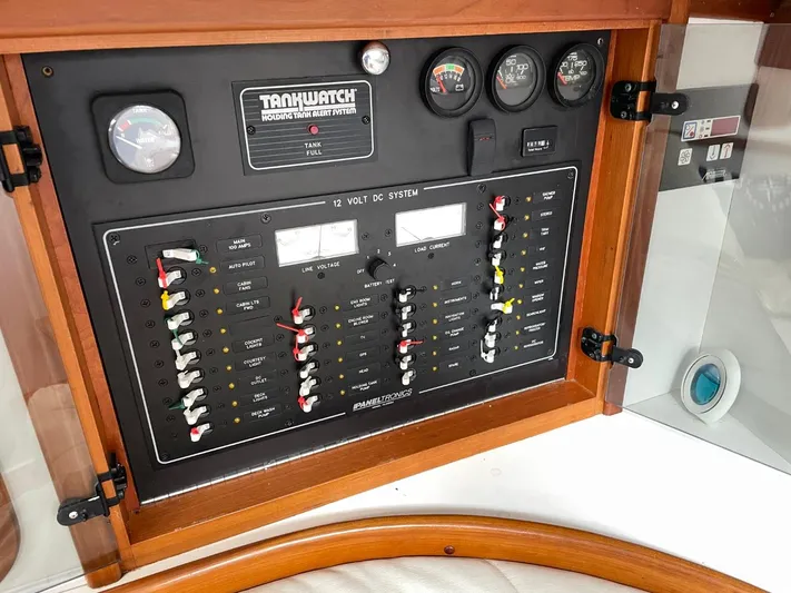 Don't Blink Yacht Photos Pics Control panel of a 1999 Legacy 34 Express boat, featuring gauges and switches.