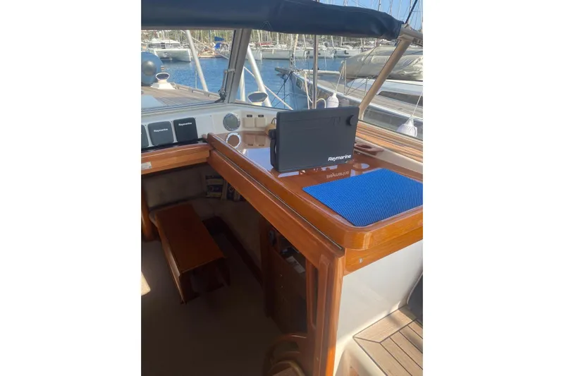  Yacht Photos Pics 2007 Hallberg-Rassy 54 yacht cockpit with Raymarine navigation equipment and wooden finish.