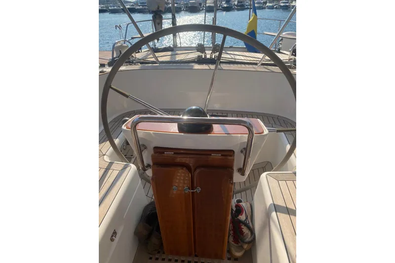  Yacht Photos Pics Steering wheel of a 2007 Hallberg-Rassy 54 yacht, docked at a marina.
