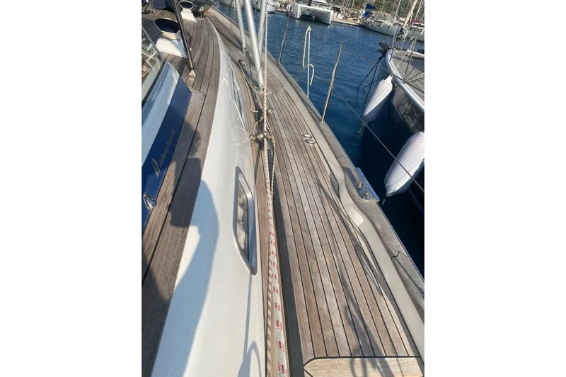  Yacht Photos Pics 2007 Hallberg-Rassy 54 yacht deck with wooden finish, docked at marina.