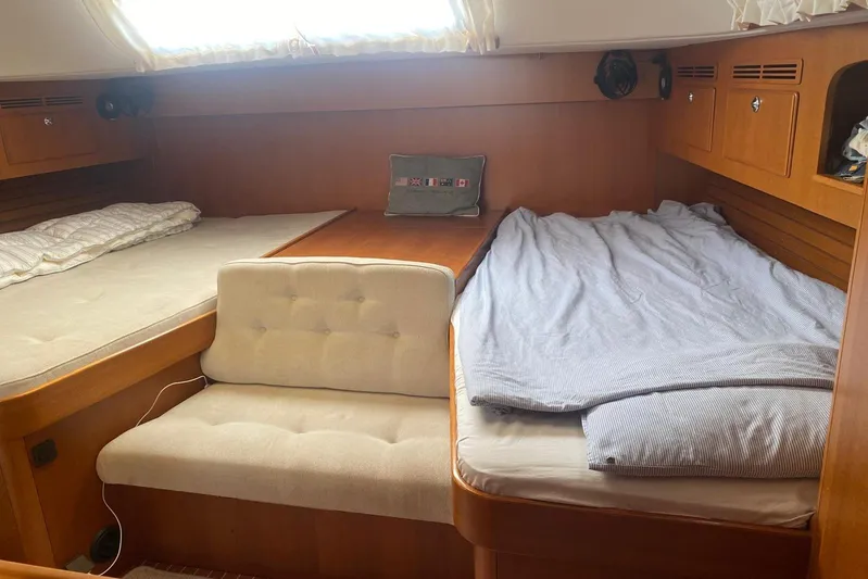  Yacht Photos Pics Cozy cabin interior of 2007 Hallberg-Rassy 54 yacht with twin beds and seating.