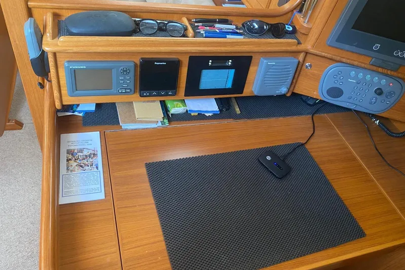  Yacht Photos Pics Navigation station of a 2007 Hallberg-Rassy 54 yacht with electronic equipment and accessories.