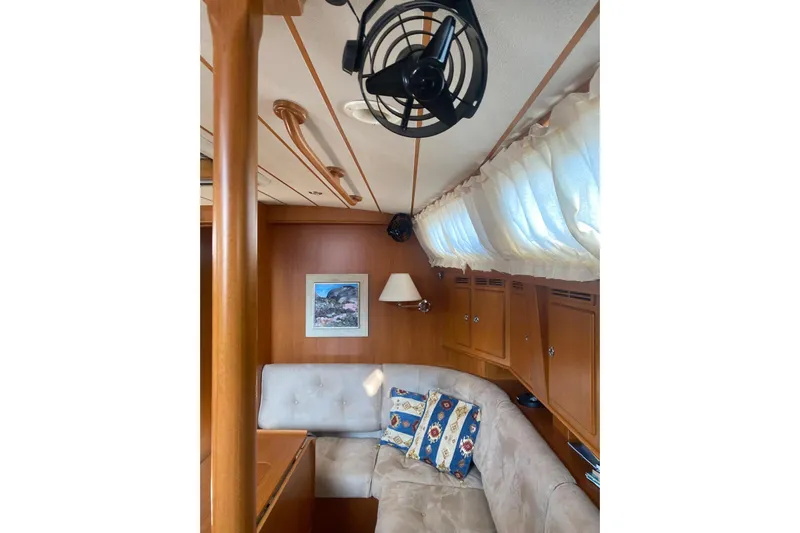  Yacht Photos Pics Cozy interior of 2007 Hallberg-Rassy 54 yacht with plush seating and nautical decor.