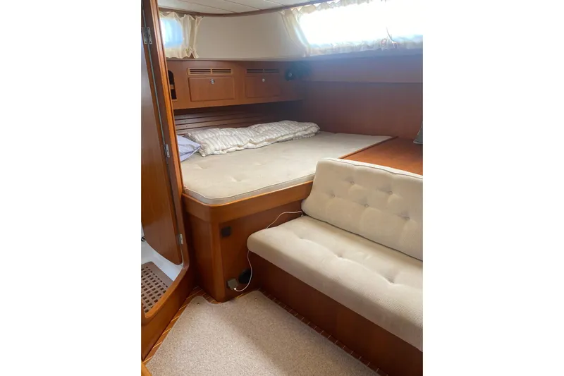  Yacht Photos Pics Cozy cabin interior of 2007 Hallberg-Rassy 54 yacht with bed and seating.