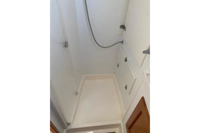  Yacht Photos Pics Shower area in a 2007 Hallberg-Rassy 54 yacht, featuring white walls and fixtures.
