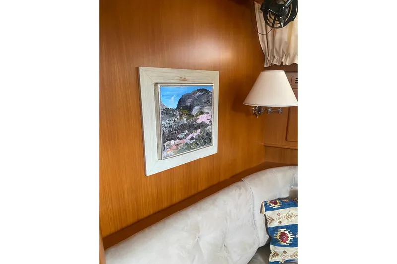  Yacht Photos Pics Interior of 2007 Hallberg-Rassy 54 yacht with framed painting and wall lamp.