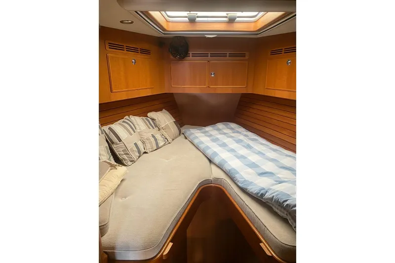  Yacht Photos Pics Cozy cabin interior of 2007 Hallberg-Rassy 54 yacht with comfortable bedding.