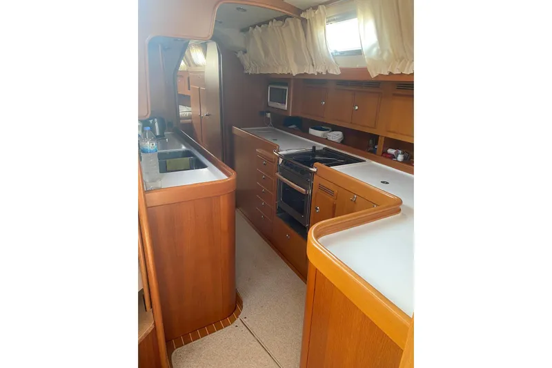  Yacht Photos Pics Luxurious 2007 Hallberg-Rassy 54 yacht interior with modern kitchen amenities.